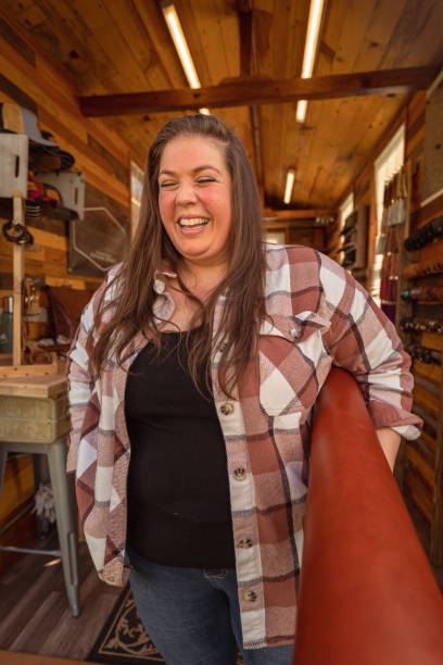 istock Female small business owner laughing in workshop 1404760310
