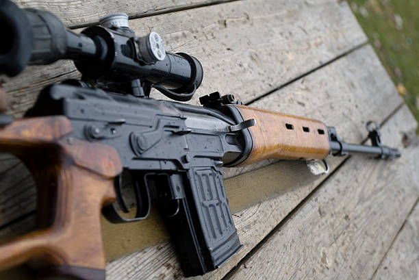 istock Rifle gun laying on wooden desk 140476225
