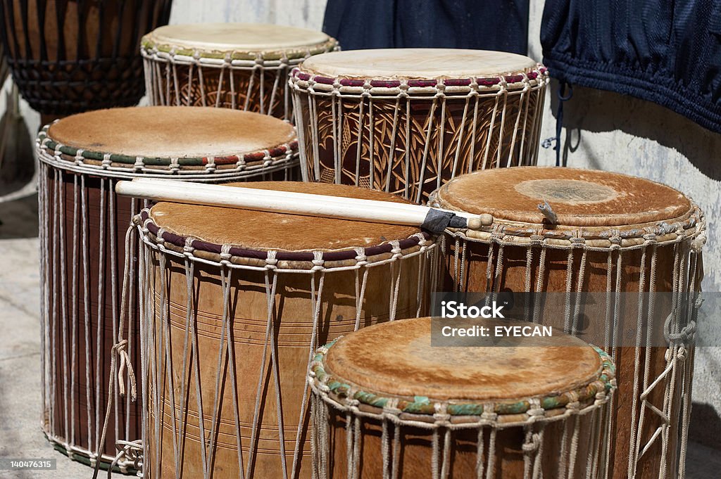 African drums set (jembe, tam-tam) and sticks Traditional african drums set (jembe, tam tam) played by hands and bass drums played with drumsticks, horizontal Drum - Percussion Instrument Stock Photo