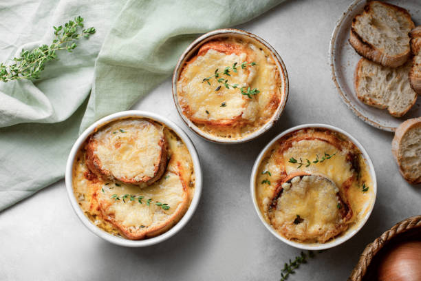 French homemade onion soup with cheese and bread. Top view