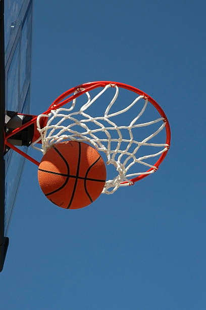 istock Basketball Swishes Through Bottom of Net 140476627