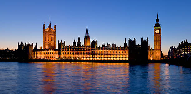 The palace of Westminster at dusk from water stock photo