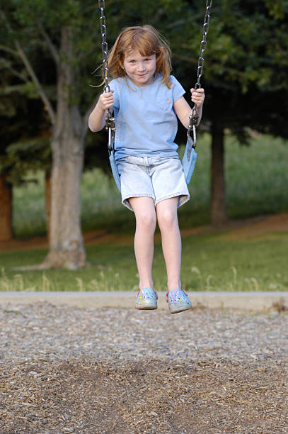 istock girl swinging at playground 140477143