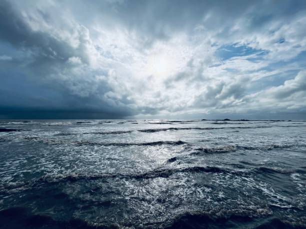 istock Rough sea shore under cloudy sky during sunset 1404771644