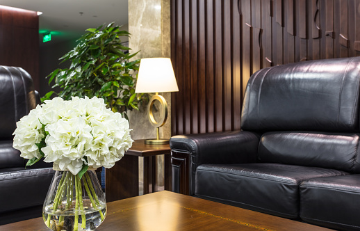 Flowers and luxury sofas in hotel waiting area