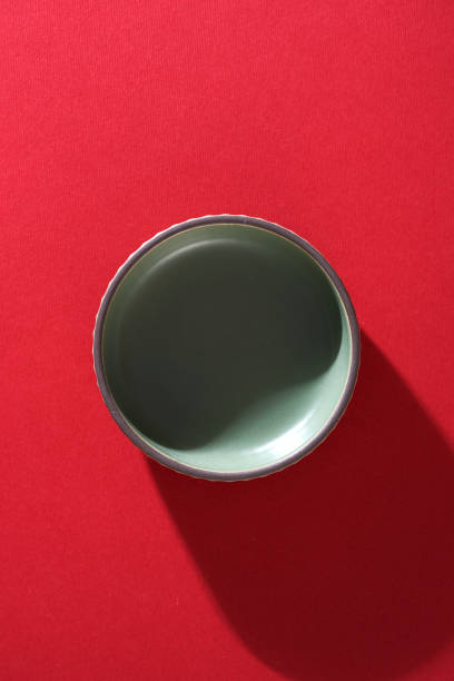 istock small saucer or bowl on red background 1404774420