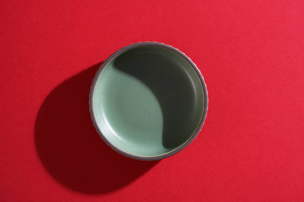 istock small saucer or bowl on red background 1404774421