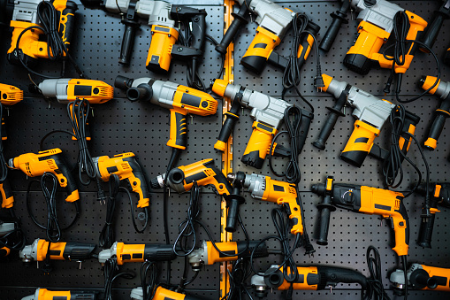 Many electric drills on the shelf