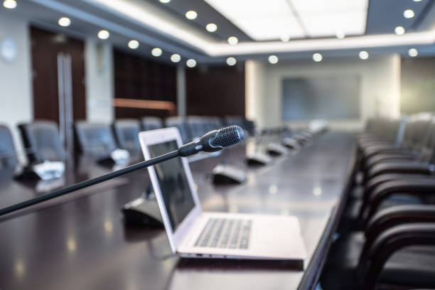 istock Isolated view of a microphone and  computer in the front of a conference room 1404776348