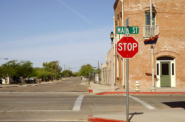 Small town intersection Main street in a small town with stop sign at an intersection rural main street stock pictures, royalty-free photos & images