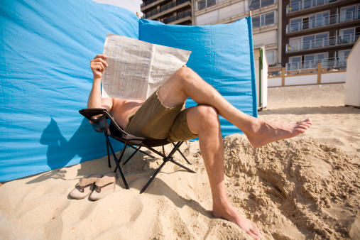 man reading his paper at the beach (3 out of 3)
