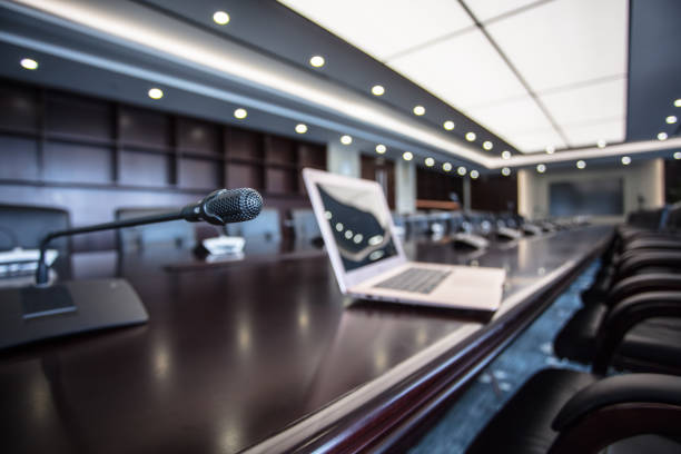 istock Laptop computer stand on wooden meeting table 1404783167