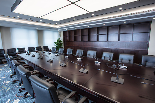 The boardroom table is set for a meeting
