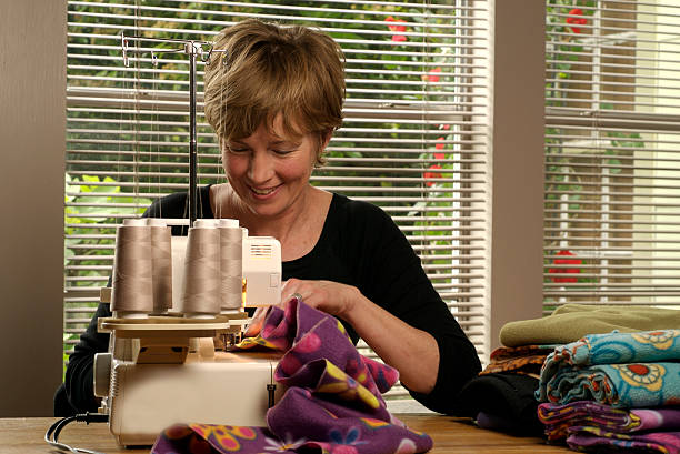 Baby Boomer Sewing at Home stock photo