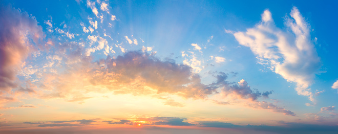 Amazing panoramic aerial view of sunset sky. Beautiful clouds and colors at dusk.