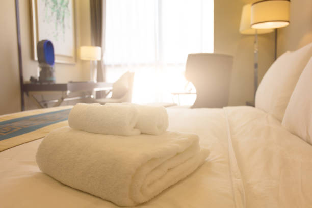 istock Clean towels on bed at hotel room 1404788016