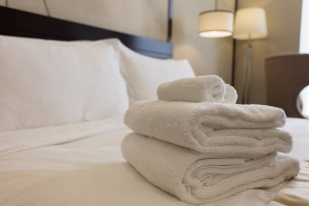 istock White towels on bed in hotel bedroom closeup 1404788064