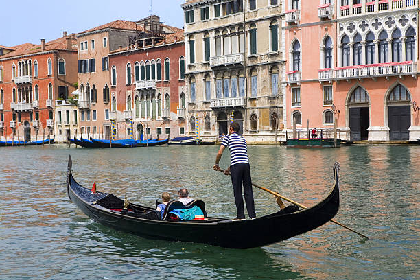 Gondolier on a gondola with passengers on the river stock photo
