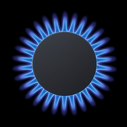 Blue flames on gas stove burner.