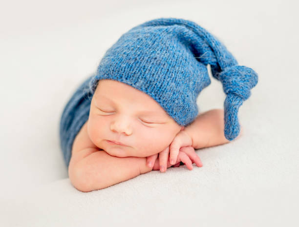 istock Cute boy in blue bonnet sleeping 1404791357