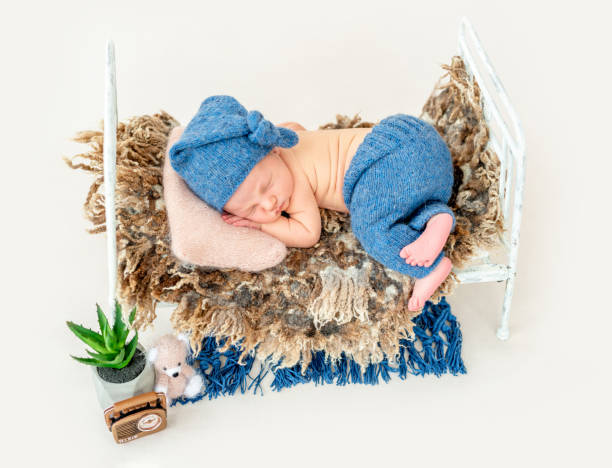 istock Cute boy in blue bonnet sleeping 1404791374