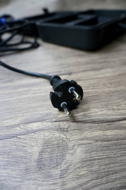 istock plug two black holes on a wooden table 1404791736