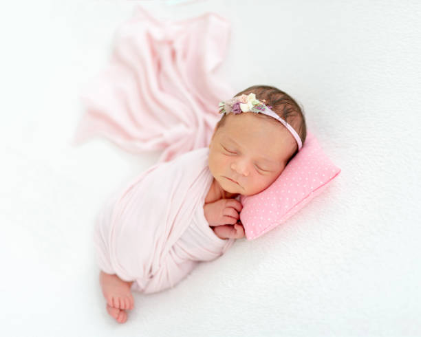 istock newborn baby sleeping on a little pillow 1404795903