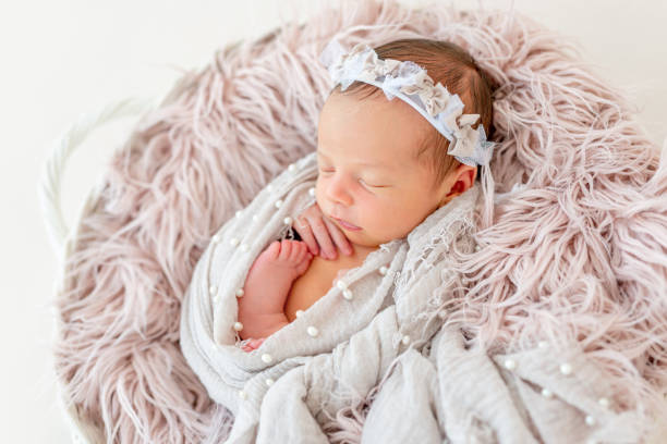 istock newborn baby sleeping in the basket 1404795923