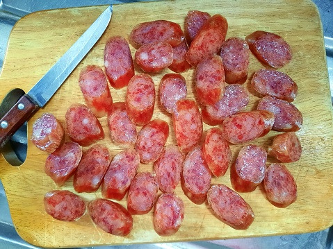 Cutting Chinese Salami Sausage - food preparation.