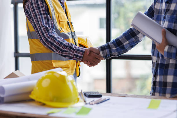 istock Architect contractor shaking hands with client after seal a deal to renovate building, engineer handshake partnership and contractor concept 1404798366
