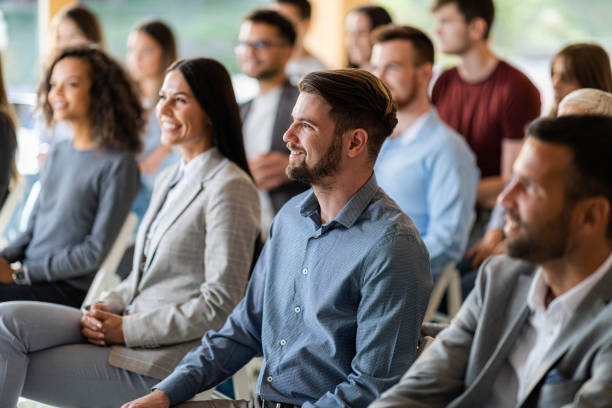 istock Happy business people having a seminar in board room. 1404800652