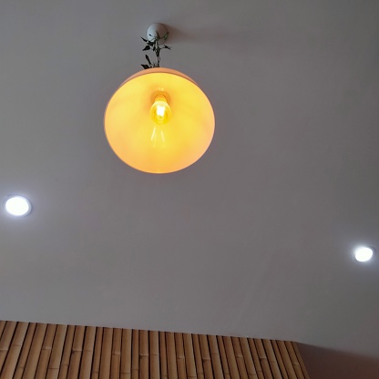 a yellow-orange chandelier that makes the atmosphere warm and relaxing