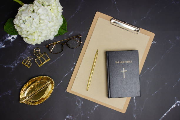 istock White hydrangea with Bible and glasses on marble background. 1404803205