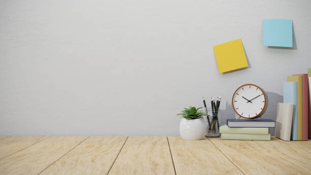 Minimal wooden work tabletop with stationery and copy space for product display over white wall.