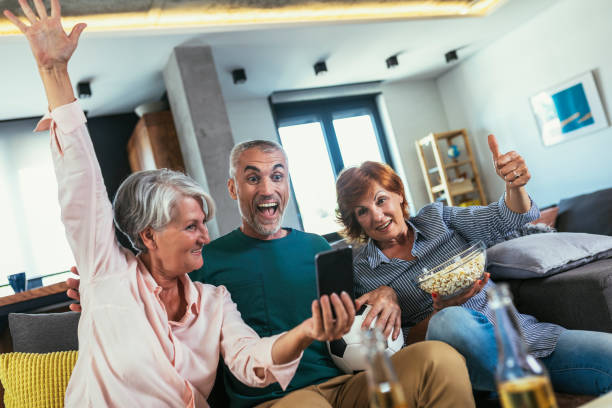 istock Group of senior using smartphone app to online bet 1404806090