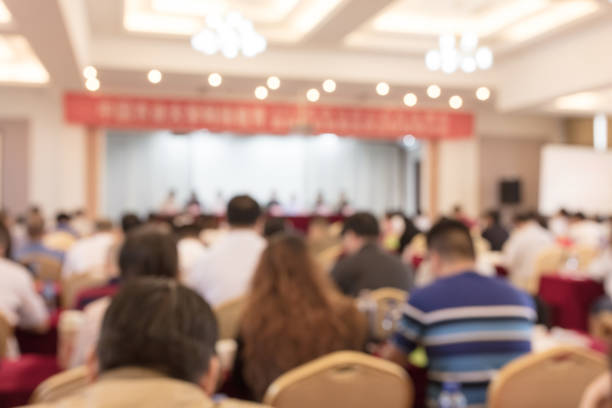 istock Blurred back view of people attending meeting 1404806192