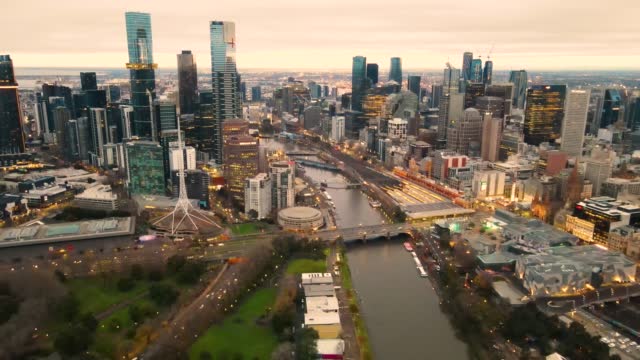 Aerial drone pullback view of Melbourne City, Victoria, Australia above Yarra River in the early morning