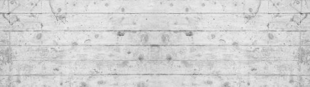 istock Abstract old white gray grey weathered damaged grunge scratched concrete cement wall texture with wood structure background banner panorama pattern 1404807398