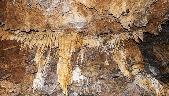 Closeup of a mountain cave with stalactites and stalagmites in Tuscany, Italy, Europe