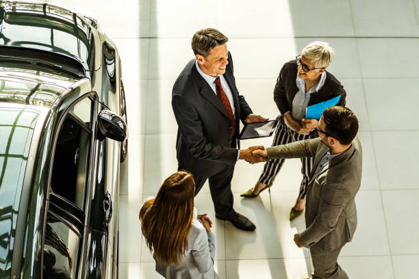 istock Successful deal in a car showroom! 1404808695