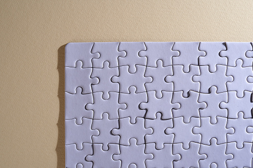 blank jigsaw puzzle on yellow background