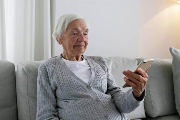 istock Older senior woman with smartphone. 1404809520