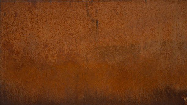 istock Grunge weathered rusty orange brown metal corten steel stone background rust texture pattern design 1404809547