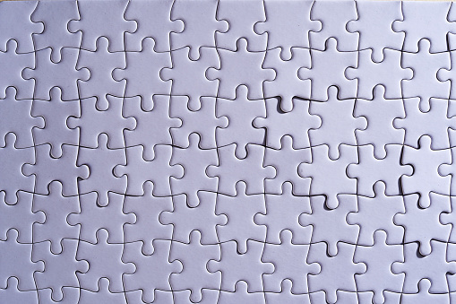 blank jigsaw puzzle on yellow background
