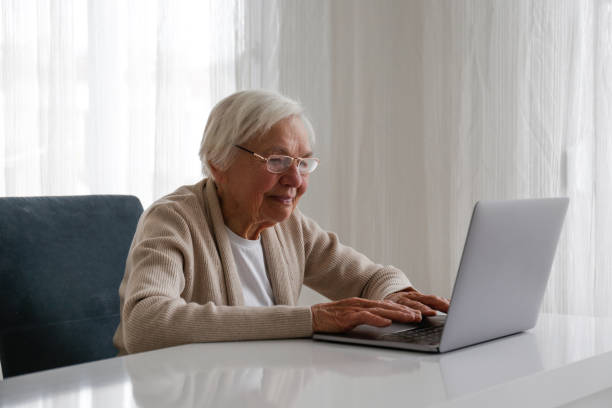 istock Older senior woman with laptop. 1404809616