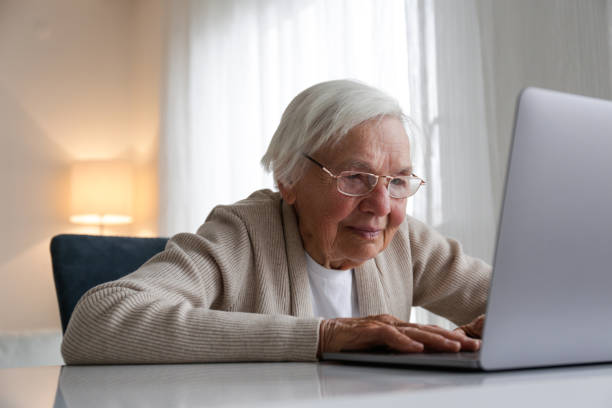 istock Older senior woman with laptop. 1404809675