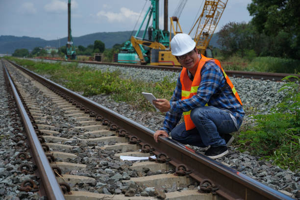 istock asian engineer working outside with a digital tablet for checking the build a high-speed railway. 1404811431
