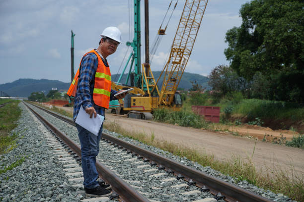 istock asian engineer working outside with a digital tablet for checking the build a high-speed railway. 1404811432