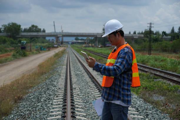 istock asian engineer working outside with a digital tablet for checking the build a high-speed railway. 1404811433