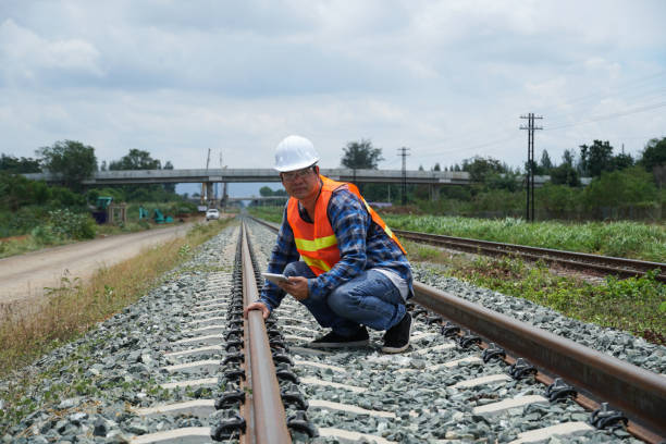 istock asian engineer working outside with a digital tablet for checking the build a high-speed railway. 1404811474